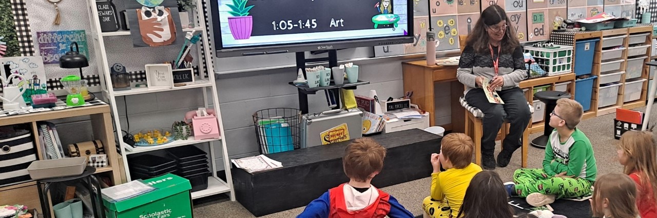 Staff reading to classroom of students