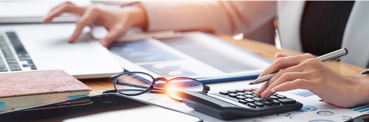 calculator and laptop on desk