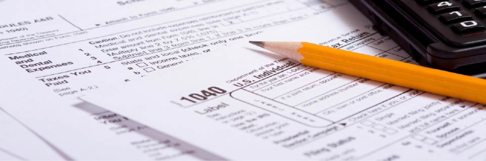 Tax forms, pencil, calculator