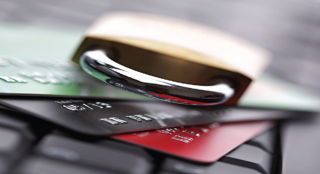 padlock on top of a stack of credit cards, on a keyboard